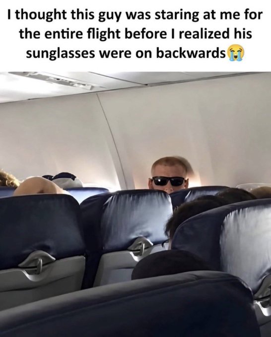 An airplane-cabin meme shows a passenger wearing sunglasses that appear to be on backward; the text reads, “I thought this guy was staring at me for the entire flight before I realized his sunglasses were on backwards😭.”
