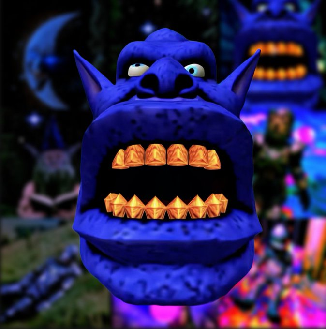 A purple, monstrous creature head with golden, gem-like teeth and small eyes stares forward against a dark, abstract background with another similar face blurred behind it.