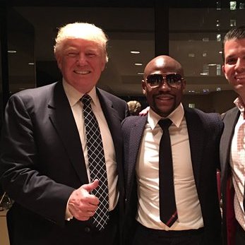 A smiling Donald Trump poses for a photo alongside boxer Floyd Mayweather Jr. and another man at what appears to be an indoor event. The image visualizes the post's claim about Mayweather being a guest at Trump's rally, with the surrounding text highlighting Mayweather's legal troubles as a point of criticism.