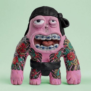 A pink and black tattooed figurine with an exaggerated grimacing face, a "ON/OFF" switch on its forehead, and sharp teeth stands against a mint green background. The image represents an NFT collectible, likely from one of the featured projects, capturing the bold and edgy art style driving excitement in the current NFT space.