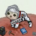 A small figurine of a kitten wearing a 'PUMA' tracksuit and cap, posed on a dusty surface next to miniature tools.