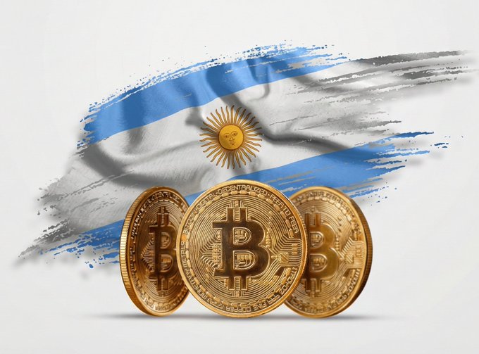 Three gold Bitcoin coins stand in front of a painted Argentine flag with the iconic Sun of May, symbolizing Argentina's leading role in Latin American crypto adoption, where roughly 1 in 5 Argentinians—about 8.5 million people—use cryptocurrency, with over 60% of transactions conducted in stablecoins for everyday survival needs.