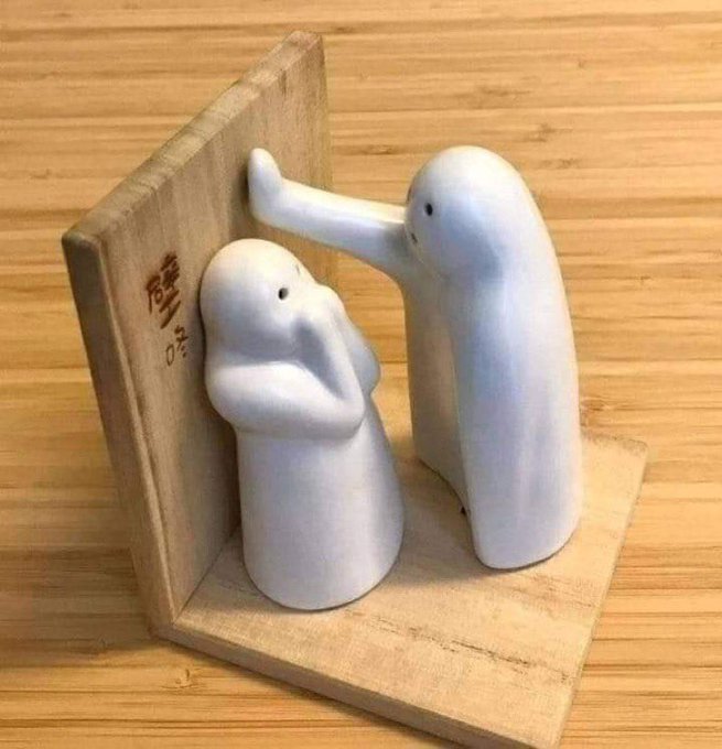 The image features two white figurines of people standing next to each other, with one figurine placing its hand on top of the other's head. The figurines are placed on a wooden surface or shelf, which appears to be made out of wood planks. There is also an accompanying text in the image that reads "X algo must be a female cuz..... You have to rub the right spot for it to favour you Am i the only one that have thought about this?". This suggests that someone has created these figurines as a form of art or expression, possibly to convey a message or evoke emotions related to gender roles and expectations.