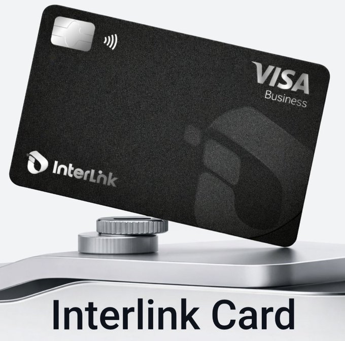A promotional graphic showing a black Visa Business credit card from InterLink balanced on a stack of coins, with the text 'Interlink Card' below.