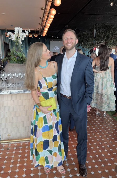 A couple is dressed up for an evening out at an upscale venue with string lights and orchids in the background, seemingly enjoying a lively social event away from screens. It fits the post's sentiment of taking a break from markets to enjoy offline leisure time over the weekend.