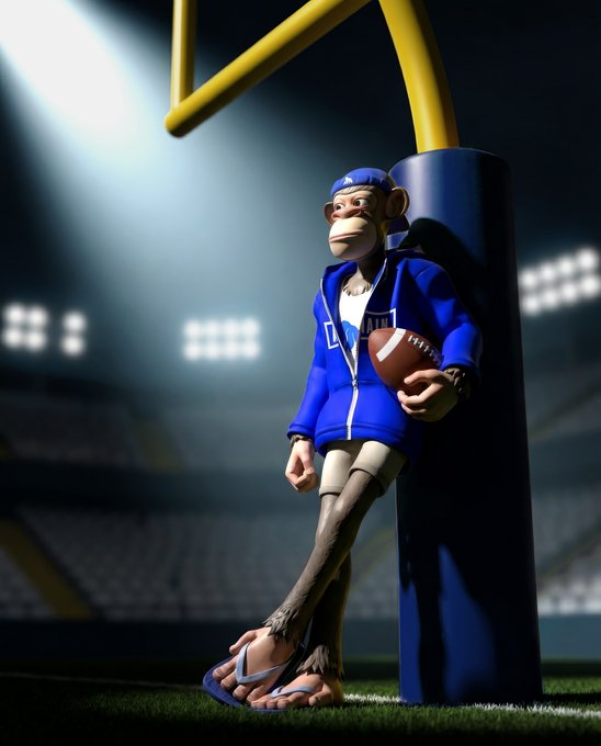 A 3D-rendered monkey character wearing a blue jersey with "APE" text, blue cap, and sandals leans against a yellow goalpost while holding an American football on a stadium field. The image ties to the "$APE" ticker by branding the playful mascot in game-day football attire, signaling a sporty, competitive spirit for the token.