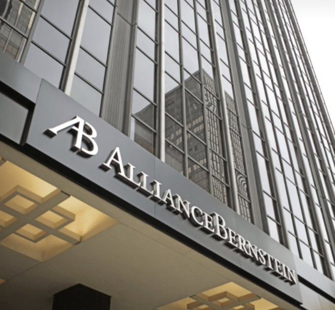 An exterior view of the AllianceBernstein office building features the company's 'AB' logo and full name 'AllianceBernstein' displayed prominently above the entrance.