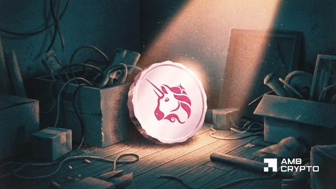 A glowing coin featuring a pink unicorn logo (Uniswap's $UNI symbol) sits in a dimly lit, cluttered room, illuminated by a dramatic beam of light—visually representing the token burning event highlighted in the post, where ~150k UNI (~$590k) were burned in a single day, a new all-time high. The "AMB Crypto" logo appears in the bottom right corner.