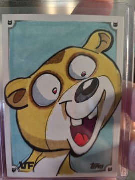 A Topps trading card featuring a cartoon bear character with a wide excited smile and bulging eyes against a blue background.