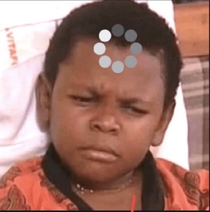 A close-up of a young boy with a confused facial expression, wearing an orange shirt and necklace, with a loading spinner icon overlaid on his forehead.