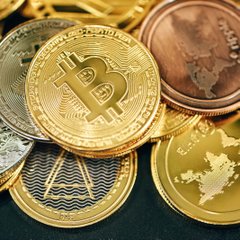 Gold Bitcoin and cryptocurrency coins piled together, representing the booming MENA blockchain transaction value projected to triple to $350B by 2025-2026.