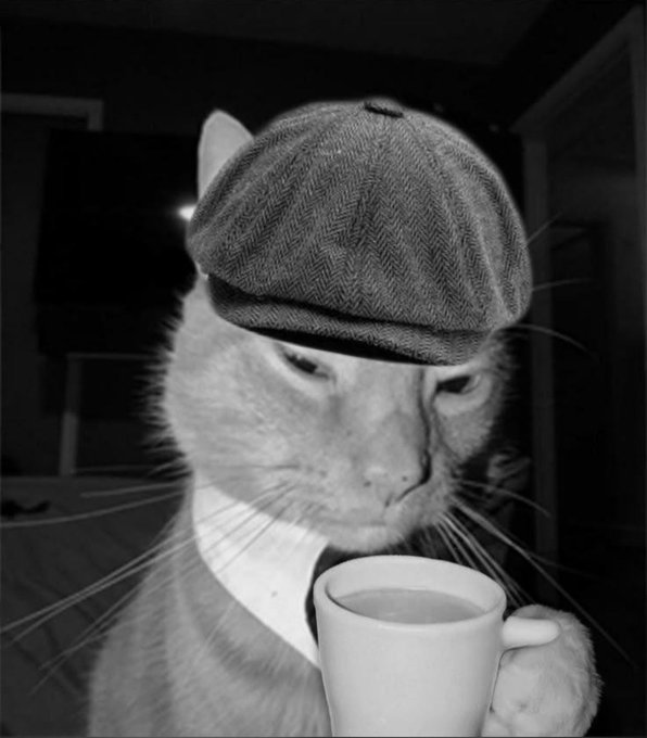 A black and white photo of a white cat wearing a flat cap, dressed in a suit and tie, holding and drinking from a white cup of coffee or tea.