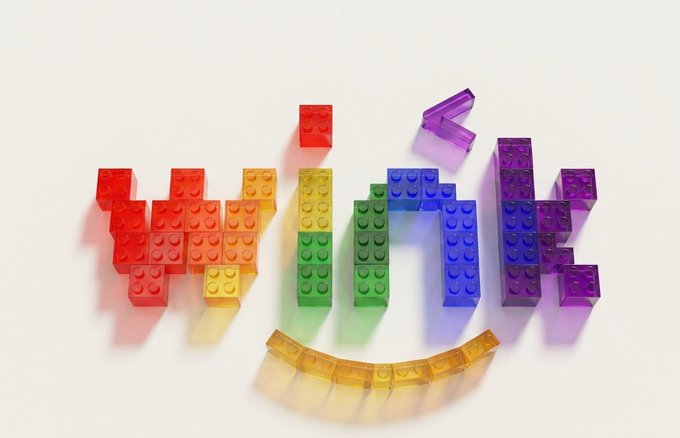 Colorful translucent LEGO bricks arranged to spell the word 'HOME' in a rainbow gradient, with a curved row of yellow bricks forming a smile underneath.