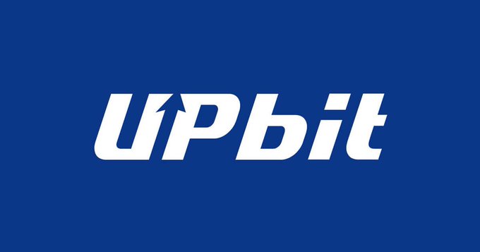 The white Upbit cryptocurrency exchange logo displayed on a solid blue background.