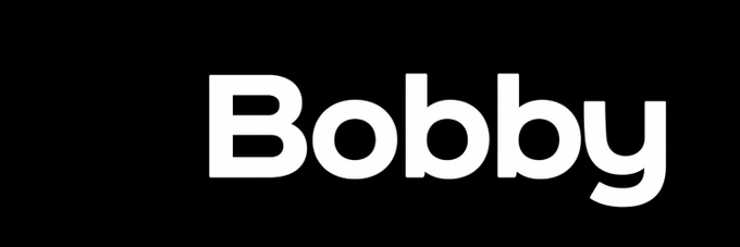 A bold black banner displays the name "Bobby" in large white sans-serif lettering, serving as the logo or title card for the @BobbyBuyBot referenced in the post promoting its return to the spotlight.