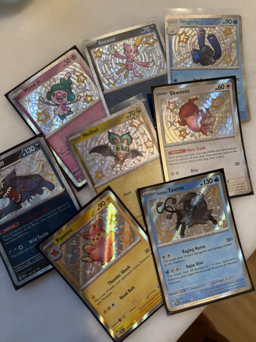 A collection of valuable Pokémon trading cards is scattered across a surface, featuring shiny holographic cards like Wimpod, Sneasel, Vaporeon, Skwovet, Noibat, Gholdengo, Pawmi, and Paldean Tauros. The post notes these rare and high-value cards were unexpectedly found hidden in an old bulk bin, suggesting a lucky discovery of cards that shouldn't have been lumped in with common ones.