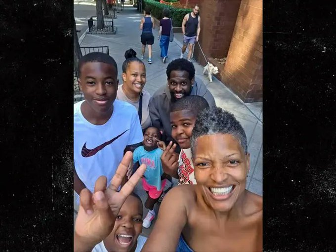 A smiling woman takes a selfie with her family on a sidewalk, capturing a happy moment that contrasts with the troubling post about Alisha Goods, who vanished after leaving for CVS and whose phone was later used to solicit bitcoin from her loved ones.