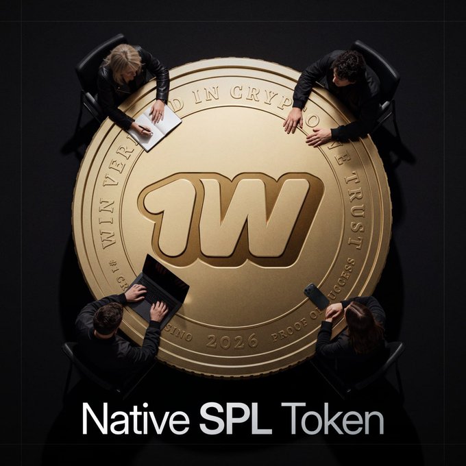 Four people gather around a giant gold '1W' coin with text 'Native SPL Token' and 'WIN VERIFIED IN CRYPTO TRUST PROCESS 2026'.