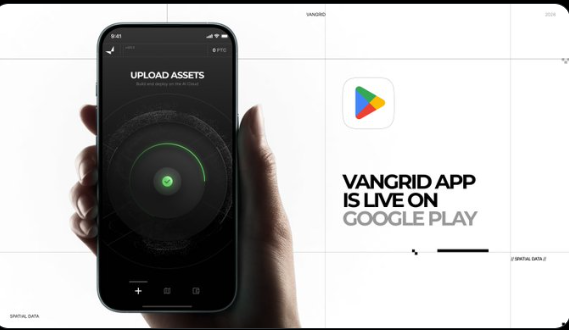 A promotional graphic showing a hand holding a smartphone with an 'UPLOAD ASSETS' screen, accompanied by text announcing 'VANGRID APP IS LIVE ON GOOGLE PLAY' alongside the Google Play logo.
