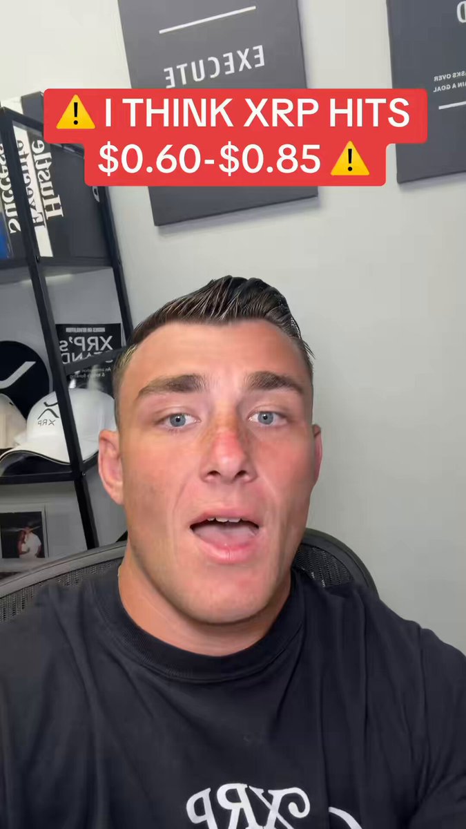 In the image, there is a man wearing a black t-shirt sitting in an office chair with his mouth open, making a funny or strange facial expression that could be interpreted as "thought XRP hits" by some viewers of this post on social media. The post suggests that he might have thoughts about investing in Bitcoin due to its recent rise in value. However, it also warns against buying Bitcoin without fully understanding the risks involved since its value can drop before a bull market begins. Thus, he is preparing for possible losses and stacks cash as a precautionary measure.