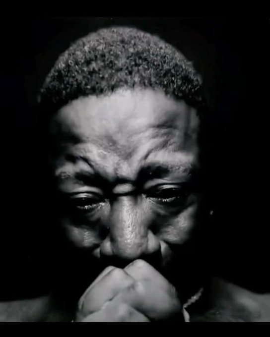 A black-and-white close-up portrait of a person wearing a knit cap, with a clenched fist held up to their mouth and a serious, contemplative expression, set against a dark background. The contemplative, defiant pose visually echoes the post's message urging "Web 3 girls" to leave other girls' photos alone, conveying a tone of firm self-respect and boundary-setting.