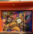 A colorful mural painting featuring stylized figures, possibly basketball players, with the number '8' visible on a jersey.