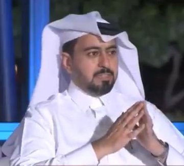A man wearing traditional Gulf attire (white thobe and ghutra) with a beard is shown with his hands raised near his face, likely speaking in an interview setting. The image does not appear to directly relate to the post about Sidra blockchain maintenance delays, as no logos, text, or identifying information for the cryptocurrency project are visible—only an unrelated man in traditional clothing.