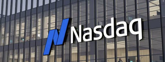 The NASDAQ logo displayed on the glass facade of a modern office building.