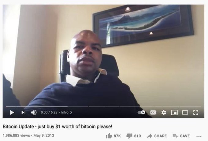 A YouTube video screenshot titled 'Bitcoin Update - just buy $1 worth of bitcoin please!' showing a man on webcam, uploaded May 9, 2013 with 1,986,883 views.