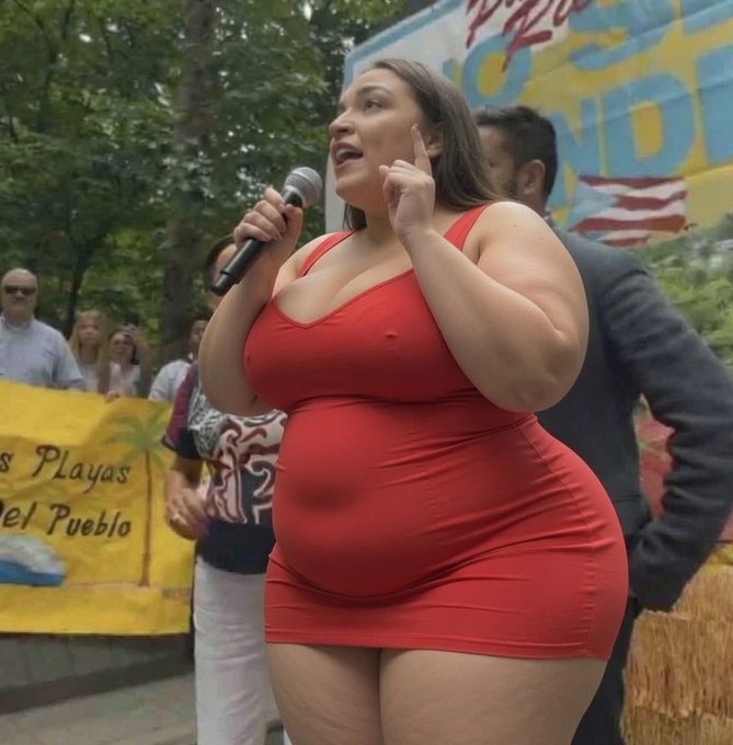 A woman in a tight red dress speaks passionately into a microphone at an outdoor rally, with banners reading "Playas" and "el Pueblo" visible behind her, embodying the post's bold call to "go even bigger."