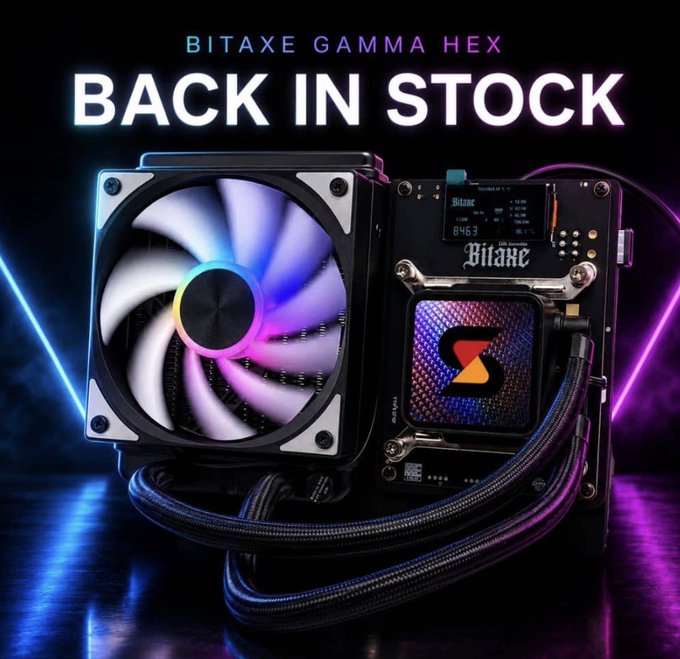 Promotional graphic for 'BITAXE GAMMA HEX BACK IN STOCK' showing a Bitaxe crypto mining device with an RGB cooling fan and digital display.