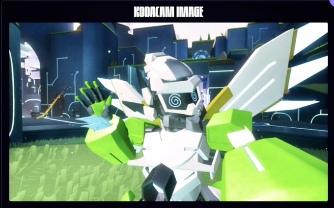 A screenshot labeled 'KODACAM IMAGE' showing a white and green winged robotic character in a blocky 3D game environment.