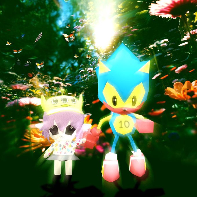 Two animated characters, one blue and one purple with a yellow crown, stand in a vibrant, sunlit garden filled with flowers and butterflies.