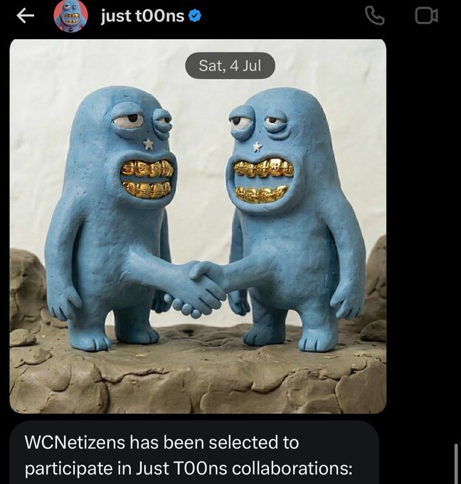 The user wants a concise caption for the image.
1.  **Identify the main subject:** Two blue clay figures (resembling the "t00ns" characters) shaking hands. They have gold teeth.
2.  **Identify the text in the image:**
    *   Top: "just t00ns" with a verified checkmark.
    *   Date stamp: "Sat, 4 Jul".
    *   Bottom text overlay: "WCNetizens has been selected to participate in Just T00ns collaborations:"
3.  **Synthesize the description:** The image shows two blue claymation-style characters shaking hands. They have gold teeth. The text indicates this is related to "WCNetizens" being selected for a collaboration with "Just T00ns".
4.  **Draft the caption:** Two blue clay figures with gold teeth shake hands, illustrating the announcement that "WCNetizens has been selected to participate in Just T00