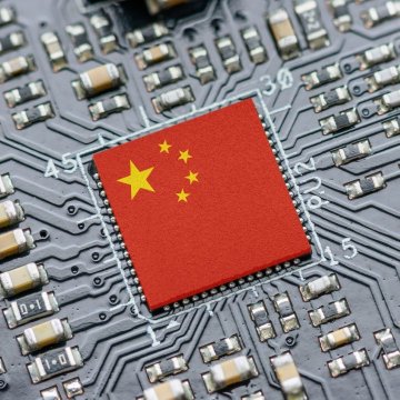 A microchip on a circuit board is overlaid with the flag of China, symbolizing the dominance of Chinese AI models. The image visually reinforces the news that U.S. firms are increasingly using Chinese AI models on OpenRouter.