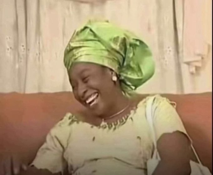 A Nigerian woman in a green gele (headwrap) and yellow dress laughs heartily while seated on a couch, perfectly capturing the mood of the post's meme about crypto investors quickly shifting their narrative—presenting themselves as "Web3 founders" during price surges and "long-term investors" during downturns.