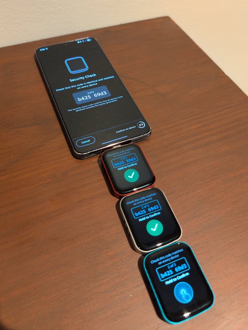 A smartphone running a "Security Check" app displays the code "b425 69d3" for an entropy input request, with three hardware wallets lined up on a wooden desk each showing the same code in their "2 of 3" Multi-Sig confirmation screens and prompting to "Hold to Confirm." This visually demonstrates the post's claim about relying on external entropy generation rather than trusting the wallets themselves to create it.