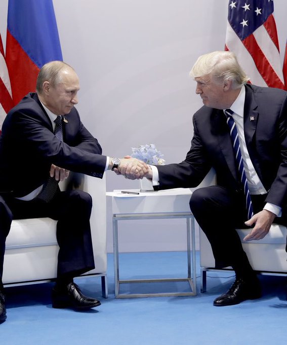 In this image, Vladimir Putin and Donald Trump shake hands, symbolizing a meeting of world leaders as their nations reportedly move towards embracing cryptocurrency.