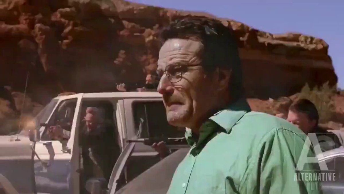 The image features a man wearing glasses standing next to a white van, with another person visible behind him. The scene appears to be set in an outdoor area or desert environment, as there are rocks present in the background. The caption for this image reads "He is the one." and it seems that the main focus of the post is on the man's character and his journey through the obstacles presented by @akashnet.