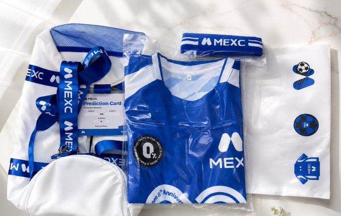 A collection of MEXC cryptocurrency exchange branded merchandise, including a jersey, lanyard, headband, and sticker sheet.