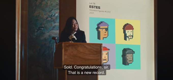 A woman speaks at a wooden podium during an auction presentation for the 'ESTES Hooded Figures #3312' NFT collection, with the caption 'Sold. Congratulations, sir. That is a new record.' visible below.