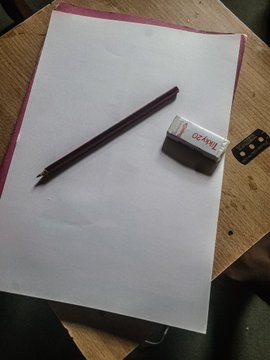 A blank sheet of paper sits on a desk with a purple pen and a red OCAMO eraser, representing an unfinished meme sketch entry for $BLKFUEL's contest that the poster is playfully asking viewers to evaluate.