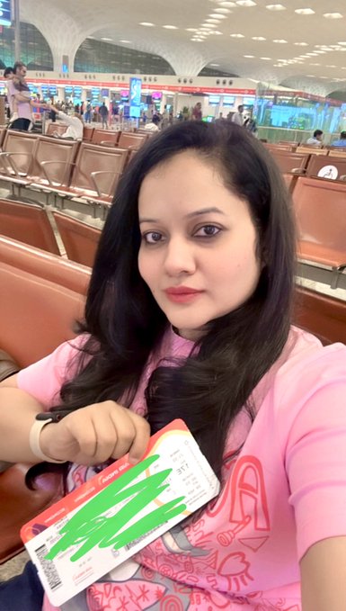 A woman in a pink shirt takes a selfie in what appears to be an airport terminal, holding an "Emirates" boarding pass while seated among rows of empty chairs. The image captures her travel moment, aligning with the post's theme of making memories and weekend recharging, with the caption playfully suggesting she "touches grass" (gets out into the world) while still staying connected to crypto markets (#BTC, #Crypto, #ETH).