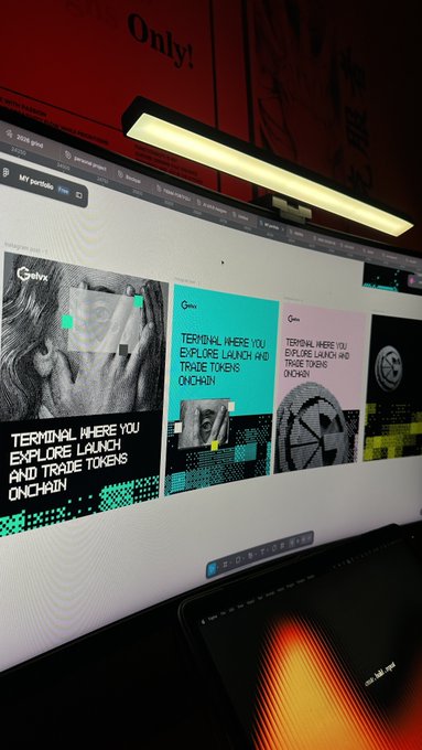 A computer monitor displays a website with the header "MY PORTFOLIO" and tiles reading "TERMINAL WHERE YOU EXPLORE LAUNCH AND TRADE TOKENS ONCHAIN" and "TERMINAL WHERE YOU EXPLORE LAUNCH AND TRADE TOKENS ONCHAIN".