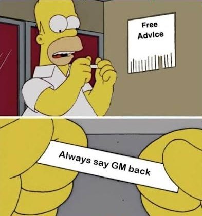 Homer Simpson from The Simpsons excitedly reading a 'Free Advice' slip that reads 'Always say GM back', a meme referencing the crypto 'GM' greeting.