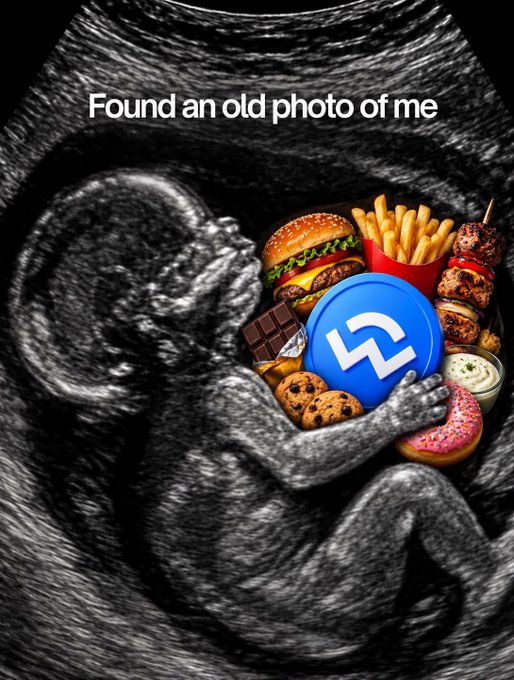 An ultrasound image of a fetus holding a pile of junk food (burger, fries, donut, cookies) and a blue crypto token icon, captioned 'Found an old photo of me'.