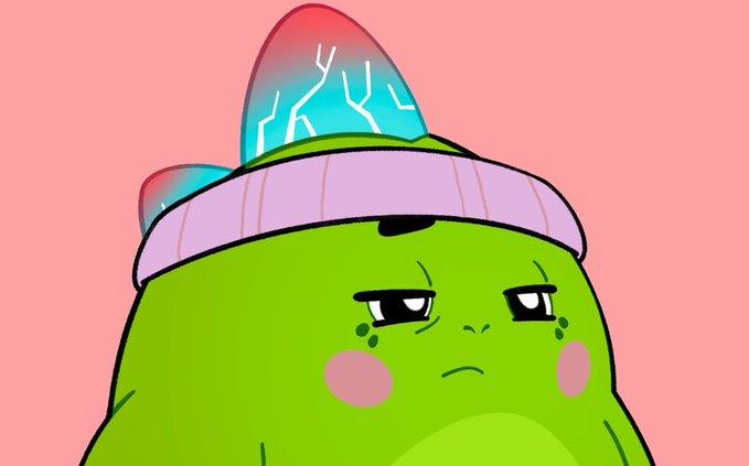 A cartoonish green blob-like character wearing a purple and teal beanie with pink cheek circles, looking displeased against a pink background.