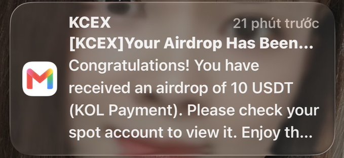A mobile notification from KCEX reading '[KCEX] Your Airdrop Has Been... Congratulations! You have received an airdrop of 10 USDT (KOL Payment). Please check your spot account to view it. Enjoy th...' received 21 minutes ago.