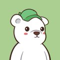 The image features a white teddy bear wearing a green hat, standing against a green background. The bear appears to be looking directly at the camera with an expression of curiosity or interest. The caption below the image provides information about the bear's favorite abstract meme/coin and the game it is associated with.