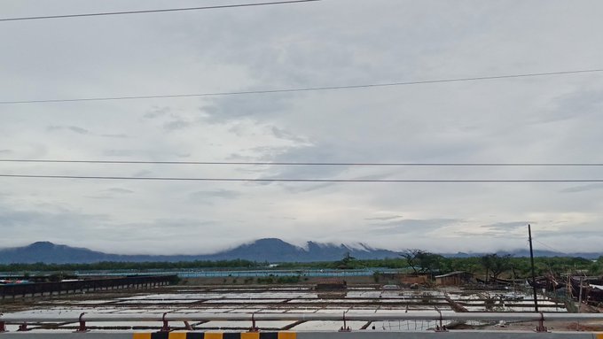 The image shows a beautiful view of a mountain range with a cloudy sky above. The mountains are covered in snow, adding to the overall serene atmosphere. In the foreground, there's an area where people have gathered for a meeting or event, indicating that this location is being used as a central point for communication and collaboration among individuals who share common interests.